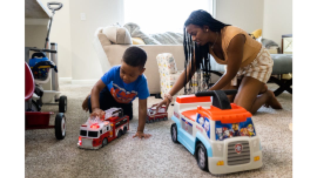 Sarah and Noah play with trucks